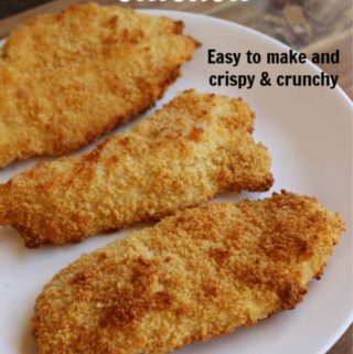 Three slices of chicken on a plate with text overlay - paleo oven fried chicken easy to make and crispy and crunchy