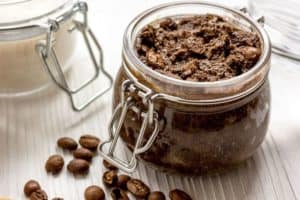 coffee scrub in jar with coffee beans
